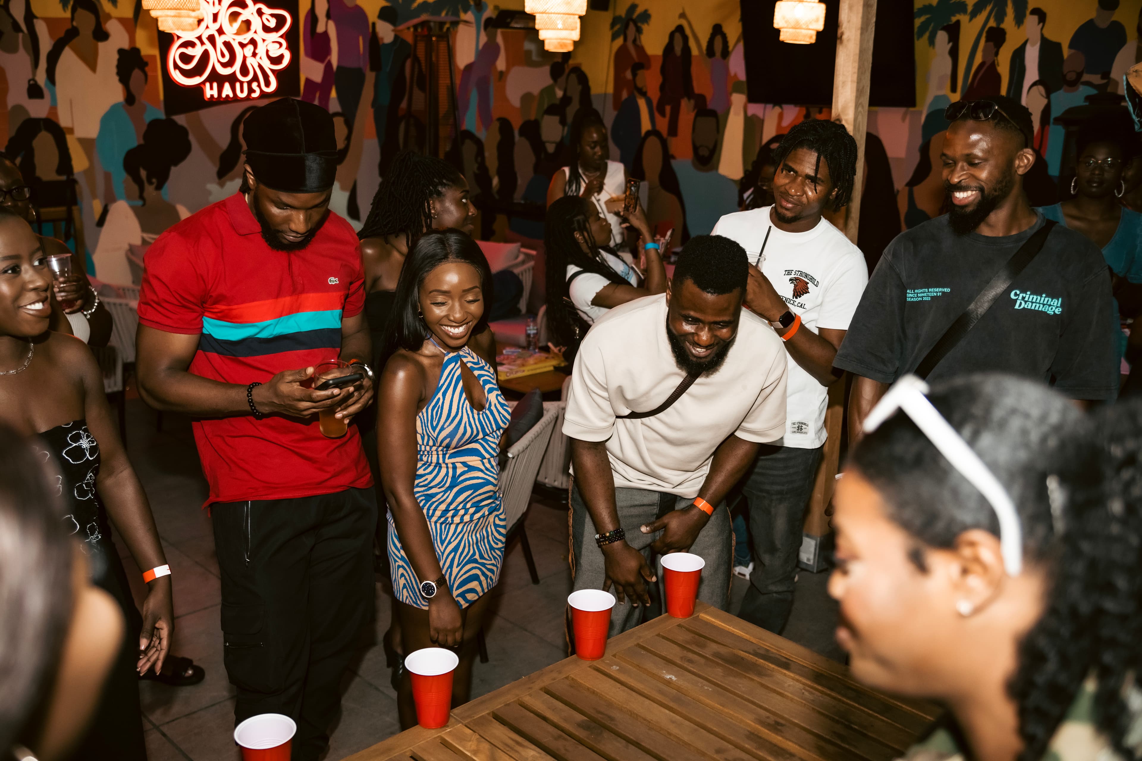 Guests sharing a laugh around a game at Kunle's Games Night